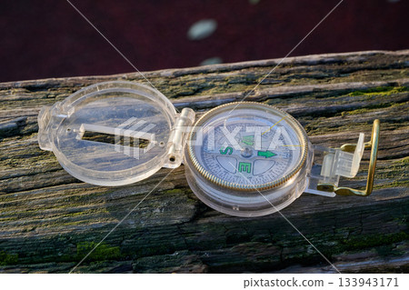 small travel compass on textured wooden small travel compass on textured wooden 133943171