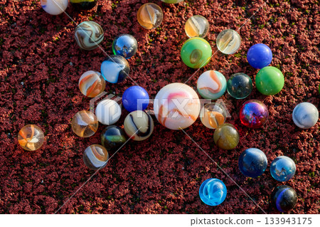 marbles of all colors and a spinning top 133943175