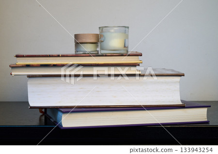 Large books and a scented candle Large books and a scented candle 133943254