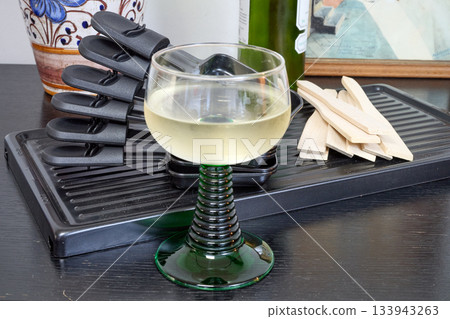 Raclette trays and wooden pallets on table 133943263