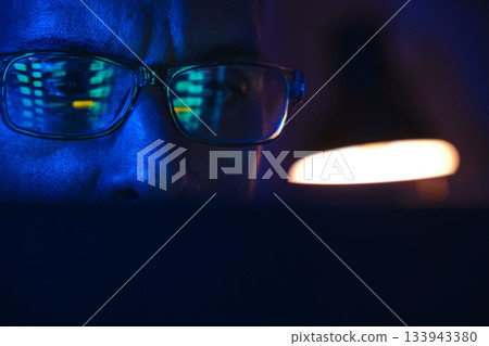 Person analyzing stock market data reflection in glasses Person analyzing stock market data reflection in glasses 133943380