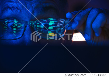 Analyzing stock market data on a screen at night 133943383