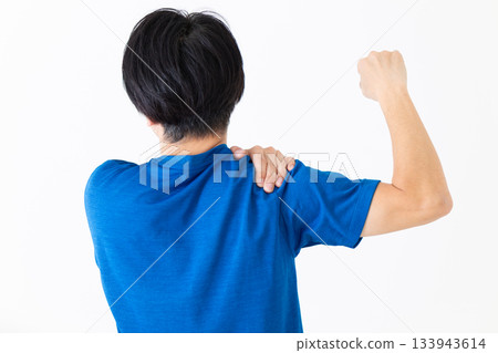 一位身穿T恤的中年男子正在做肩部伸展運動 一位身穿T恤的中年男子正在做肩部伸展運動 133943614