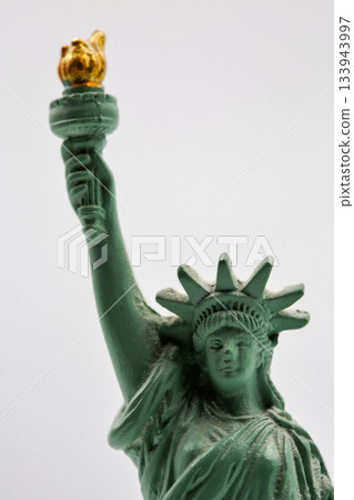 Statue of Liberty miniature figurine souvenir with green patina closeup. Statue of Liberty miniature figurine souvenir with green patina closeup. 133943997