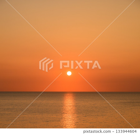 sun setting into the sea 133944604