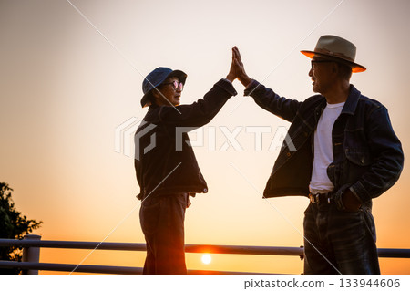 High five with the sunset High five with the sunset 133944606