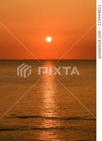 sun setting into the sea sun setting into the sea 133944611