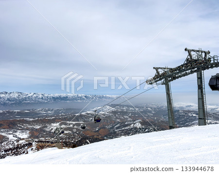 Gondola lift cabins at ski resort. Winter landscape. 133944678