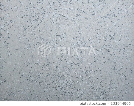 Neutral textured wall surface with a rough plaster finish for background use 133944905