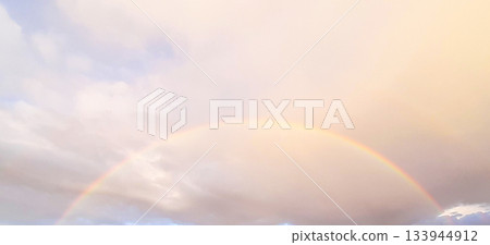Soft rainbow over pastel sky with clouds at sunset, calm, peaceful and hopeful scene Soft rainbow over pastel sky with clouds at sunset, calm, peaceful and hopeful scene 133944912