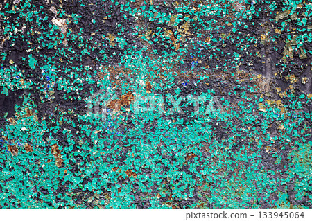 Colorful weathered wall with peeling turquoise paint and rusted texture for urban art themes 133945064