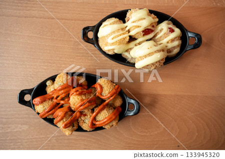 Savory bowls filled with delicious snacks drizzled with sauces for all appetites 133945320