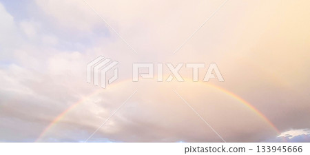 Rainbow Arch in Soft Sky Over Clouds, Pastel Light Creates Calm, Peaceful Outdoor Scene 133945666
