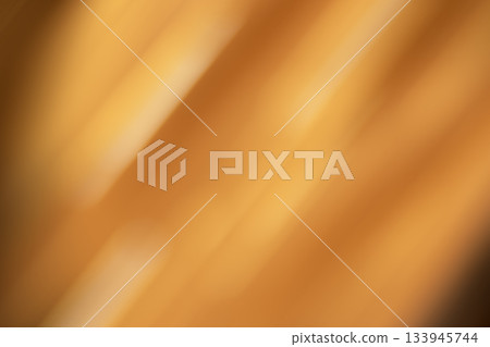 Warm orange abstract blur with soft diagonal light, creating a cozy, energetic mood and glow Warm orange abstract blur with soft diagonal light, creating a cozy, energetic mood and glow 133945744