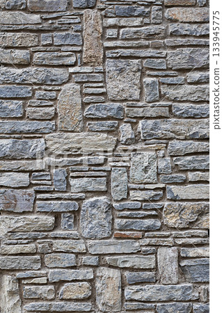 Rustic gray stone wall with irregular masonry pattern for architectural texture and exterior design Rustic gray stone wall with irregular masonry pattern for architectural texture and exterior design 133945775