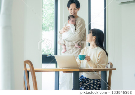 A couple teleworking at the dining table A couple teleworking at the dining table 133946598