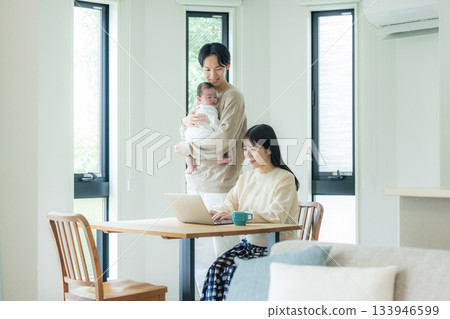 A couple teleworking at the dining table A couple teleworking at the dining table 133946599