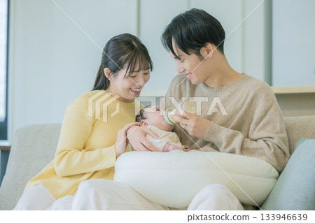 Family breastfeeding a baby on the sofa Family breastfeeding a baby on the sofa 133946639