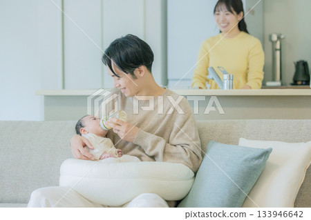 Family breastfeeding a baby on the sofa Family breastfeeding a baby on the sofa 133946642