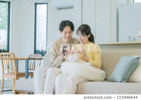 Family breastfeeding a baby on the sofa Family breastfeeding a baby on the sofa 133946644