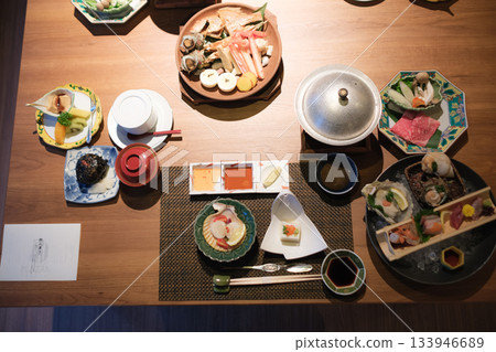 A luxurious dinner at a traditional inn featuring seafood and seasonal dishes A luxurious dinner at a traditional inn featuring seafood and seasonal dishes 133946689