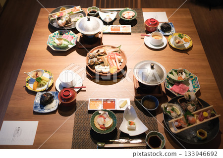 A luxurious dinner at a traditional inn featuring seafood and seasonal dishes 133946692