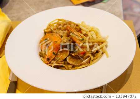 Pasta spaghetti with seafood and sauce on a table Pasta spaghetti with seafood and sauce on a table 133947072