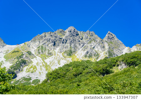 View of Mt. Karasawa and Mt. Karasawa-yari from the Karasawa tent site. Climbing Mt. Kitahotaka in the Northern Alps. 133947307