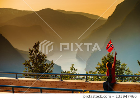 Tourist enjoy fjord view on Stegastein viewpoint Norway Tourist enjoy fjord view on Stegastein viewpoint Norway 133947466