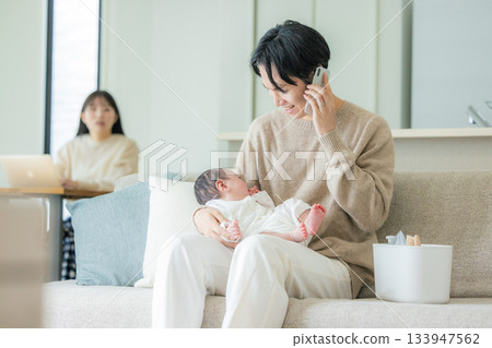 Dad and baby on the phone Dad and baby on the phone 133947562