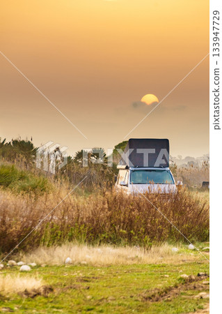 Camper van with roof top tent camp on nature 133947729