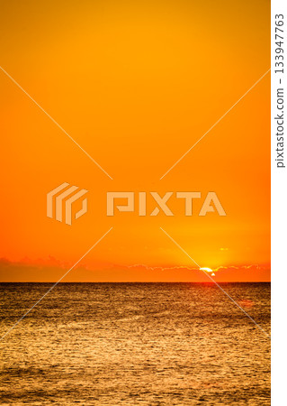 Sunset or sunrise over sea surface 133947763