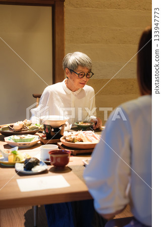 父母和孩子享受輕鬆的晚餐時光 父母和孩子享受輕鬆的晚餐時光 133947773