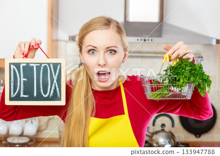 Woman holding detox sign and shopping basket with 133947788