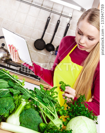 Woman having green vegetables thinking about cooking 133947789