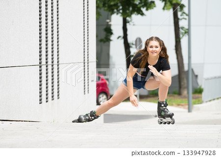 Young woman riding roller skates Young woman riding roller skates 133947928