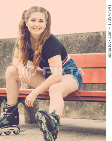 Smiling girl with roller skates outdoor 133947941