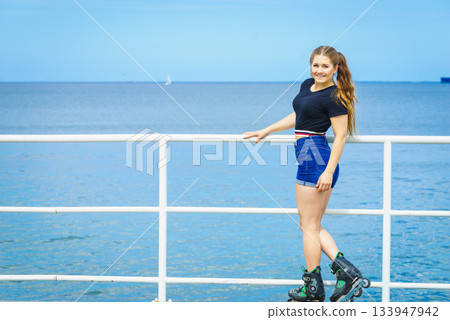 Girl wearing roller skates on seaside 133947942