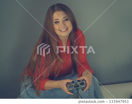 Young woman playing video games Young woman playing video games 133947951