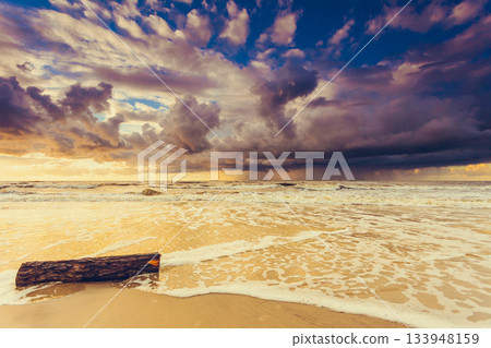 Beatiful sunset with clouds over sea and beach Beatiful sunset with clouds over sea and beach 133948159