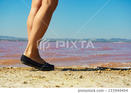 Woman on pink lake in Spain Woman on pink lake in Spain 133948404