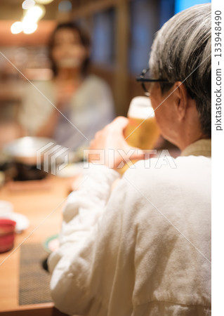 A peaceful moment where a parent and child enjoy beer at dinner at a ryokan A peaceful moment where a parent and child enjoy beer at dinner at a ryokan 133948490