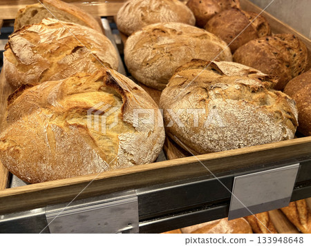 Freshly baked artisan bread loaves displayed in a bakery 133948648
