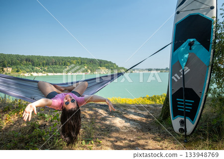 Relaxing in a Hammock by the Lake Relaxing in a Hammock by the Lake 133948769