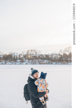 Father and child enjoying winter outdoors 133948814