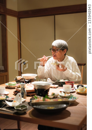 A senior couple enjoying a leisurely dinner at a traditional Japanese inn on a trip to celebrate their 60th birthday. 133948943