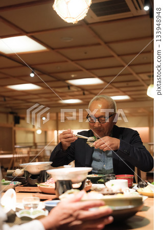 A senior couple enjoying a leisurely dinner at a traditional Japanese inn on a trip to celebrate their 60th birthday. 133948948