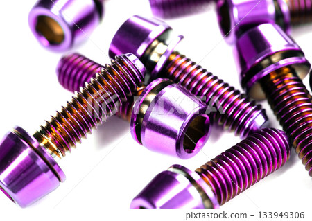 A scattering of titanium bolts in the macro are arranged on a snow-white background A scattering of titanium bolts in the macro are arranged on a snow-white background 133949306
