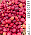 Vibrant red apples gathered at a local market showcasing autumn's harvest 133949556