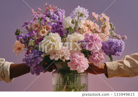 Creating a beautiful flower arrangement with vibrant blooms and joyful hands 133949615